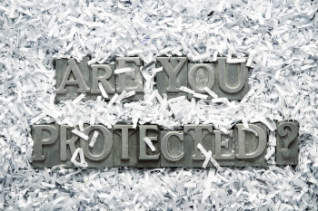 A pile of shredded paper revealing the words "Are You Protected?"