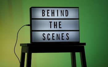 Cinema Light box sits on stool that reads "Behind the Scenes" A green screen