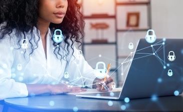 Black businesswoman working with laptop. Digital cybersecurity hologram double exposure, glowing lock and network circuit. Concept of data protection.